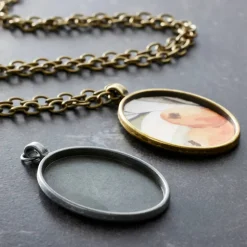 Found Objects™ Silver & Gold Oval Frame Pendants by Bead Landing™
