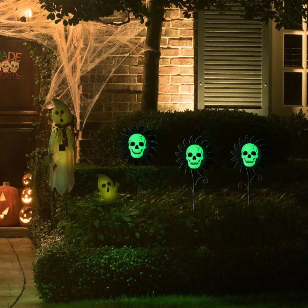 Glitzhome® 24" Halloween Metal Sunflower Skulls Glow-in-Dark Yard Stakes, 3ct.