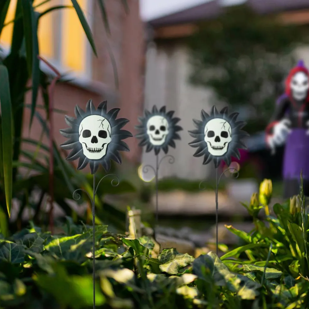 Glitzhome® 24" Halloween Metal Sunflower Skulls Glow-in-Dark Yard Stakes, 3ct.